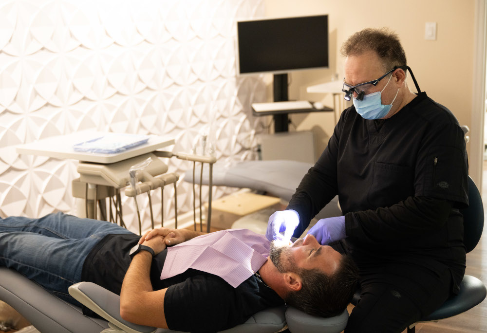 Dr. Zukaey Allababidi treating a patient at Lumiere Dental