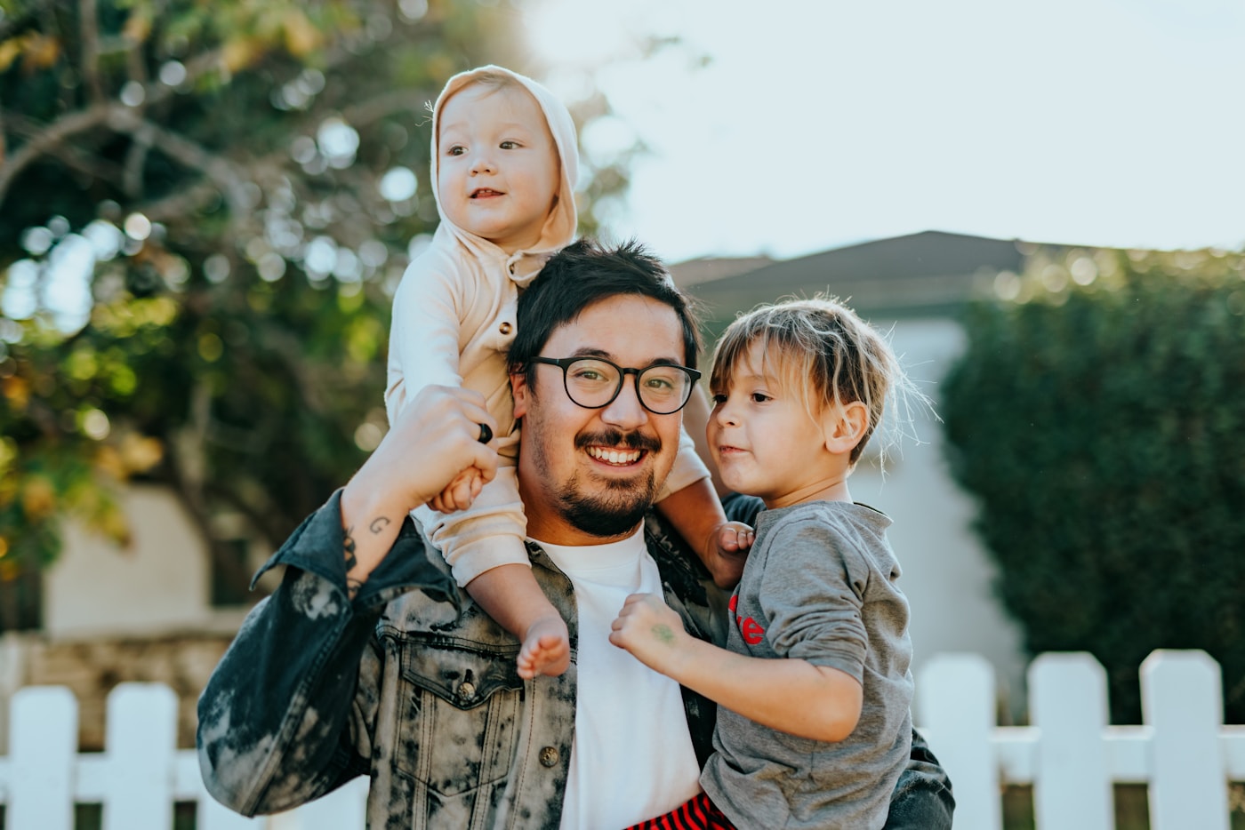 Parent smiling with two young children
